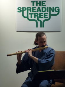 Photo of the composer performing at the Spreading Tree Gallery