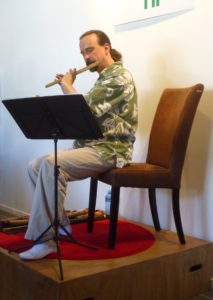 Photo of the composer performing at the Spreading Tree Gallery